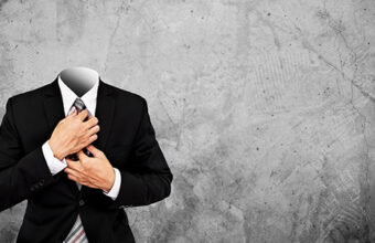 Headless businessman on concrete texture background with copy sp